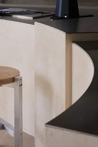 Close-up image of a modern indoor concrete stool with a wooden seat and metal frame.