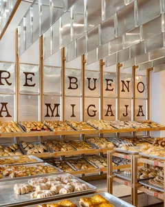 Bakery store interior displaying various baked goods on shelves.