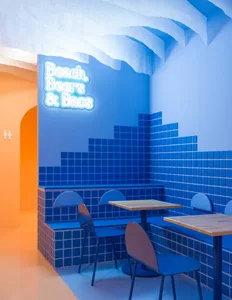 Modern restaurant interior with blue tiled walls and seating