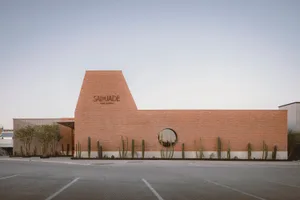 Modern building exterior with brick facade and circular window