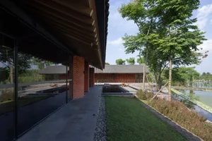 A modern residential building featuring brick and glass materials.