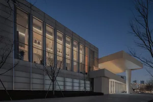Modern building with large glass windows and exterior architectural features.