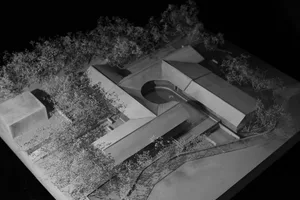Modern residential architecture model featuring brick and concrete materials and a roof.