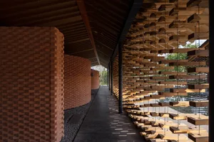 Modern corridor with wood slats and brick walls