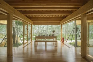 A minimalist interior design featuring a wooden floor and wooden ceiling.