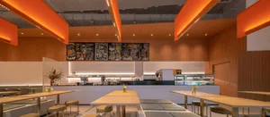 Modern cafe interior with tables, chairs, and menu board