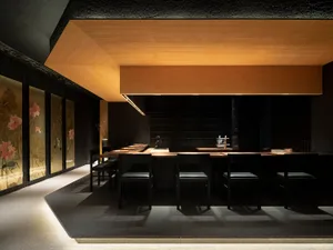 A minimalist modern restaurant bar with concrete and wooden finishes