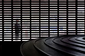 Metallic spiral object in a minimalist interior setting.
