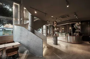 Modern coffee shop interior featuring concrete materials.