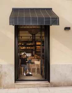 Modern cafe interior with glass facade and wood elements