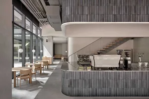 A modern coffee shop with concrete and steel interior design features