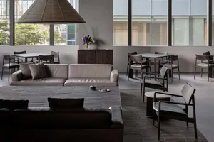Modern coffee shop interior with comfortable seating and wooden furniture, featuring a large window and contemporary design.