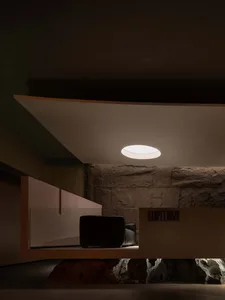Modern interior design with stone walls and a floating ceiling light
