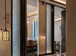 Modern interior design of a restaurant featuring glass panels and elegant lighting fixtures.