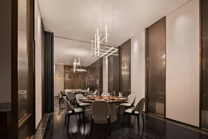 Modern restaurant interior with wooden tables, metal chairs, and glass lighting fixtures.