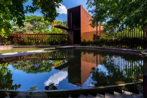 A modern architectural water feature with metal and concrete elements.