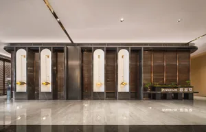 Modern hotel lobby featuring sleek, minimalist design with metal and wood accents.