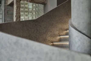 Industrial-style staircase with metallic cladding and built-in lighting
