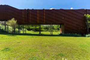 Modern, architectural design featuring a flat, rusted metal roof.