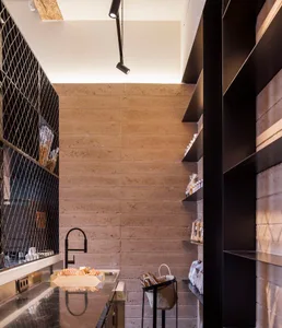A minimalist pantry with concrete walls and shelves.