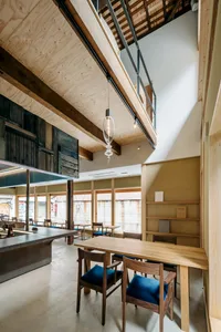 An industrial commercial space featuring wooden interiors with high ceilings and exposed beams.