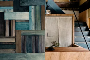 A minimalist interior space featuring wood paneling with various shades and textures.