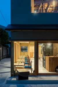 Modern restaurant interior with wooden tables and chairs.