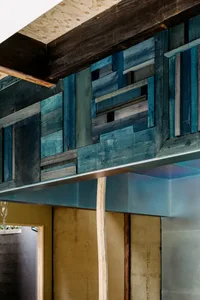 A modern retail storefront with concrete walls and metallic accents.