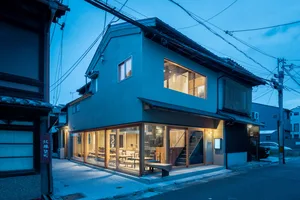 Modern storefront with glass windows and a cement exterior.
