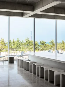 Industrial interior with concrete floors and stools.