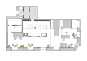 An industrial office space with workstations and a kitchen area.