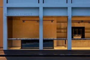 Modern storefront with large glass windows and minimalistic design.