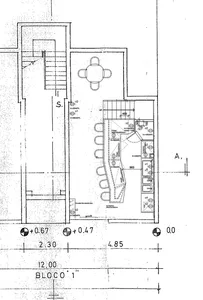 A detailed architectural blueprint of a modern shop interior, featuring a layout of rooms, furniture, and fixtures.
