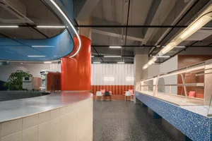 Modern interior design of a food court featuring concrete and metal elements.