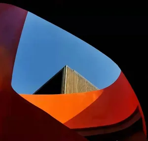 A modern interior design featuring geometric shapes and concrete surfaces.