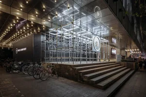 A modern interior space featuring a metallic grid structure.