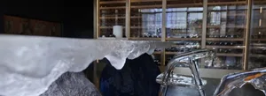 Modern lounge area featuring a transparent glass chair and table