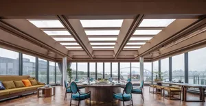 Contemporary restaurant interior featuring modern furniture, wooden floors, glass windows, and metal accents.