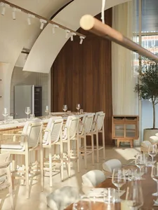 Modern restaurant interior with wooden tables, glassware, and stone accents.