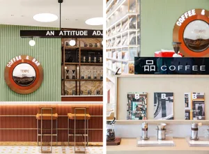 Interior of a modern coffee shop with a focus on a coffee bar with wooden stools, metal shelves, and glass display cases.