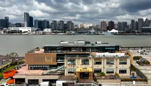 Modern cityscape featuring waterfront buildings and tall skyscrapers.
