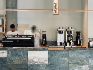 Marble coffee shop counter with espresso machines and cups