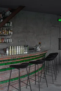 Industrial-style bar interior with exposed brick walls and glass accents
