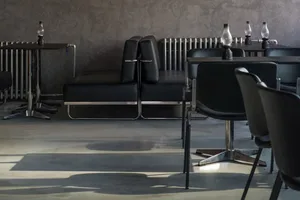 Minimalist interior with black metal furniture and leather seating.