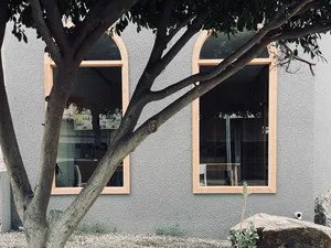 A modern coffee shop with concrete walls and glass windows.