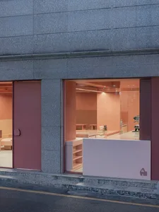 Pink-colored coffee shop interior design with pink painted walls and furniture.