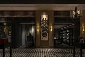A stylish, luxury lobby with wood paneling.