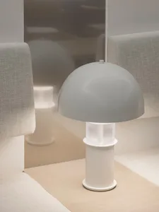 A minimalist table lamp with a white plastic base and lampshade
