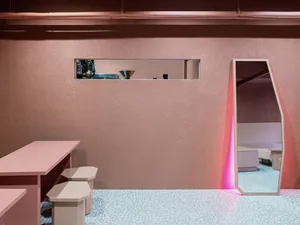 Modern cafe interior with terrazzo flooring and minimalist furniture.
