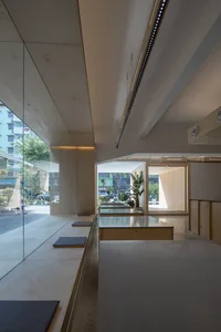 Modern interior design of a coffee shop featuring wooden and glass materials.